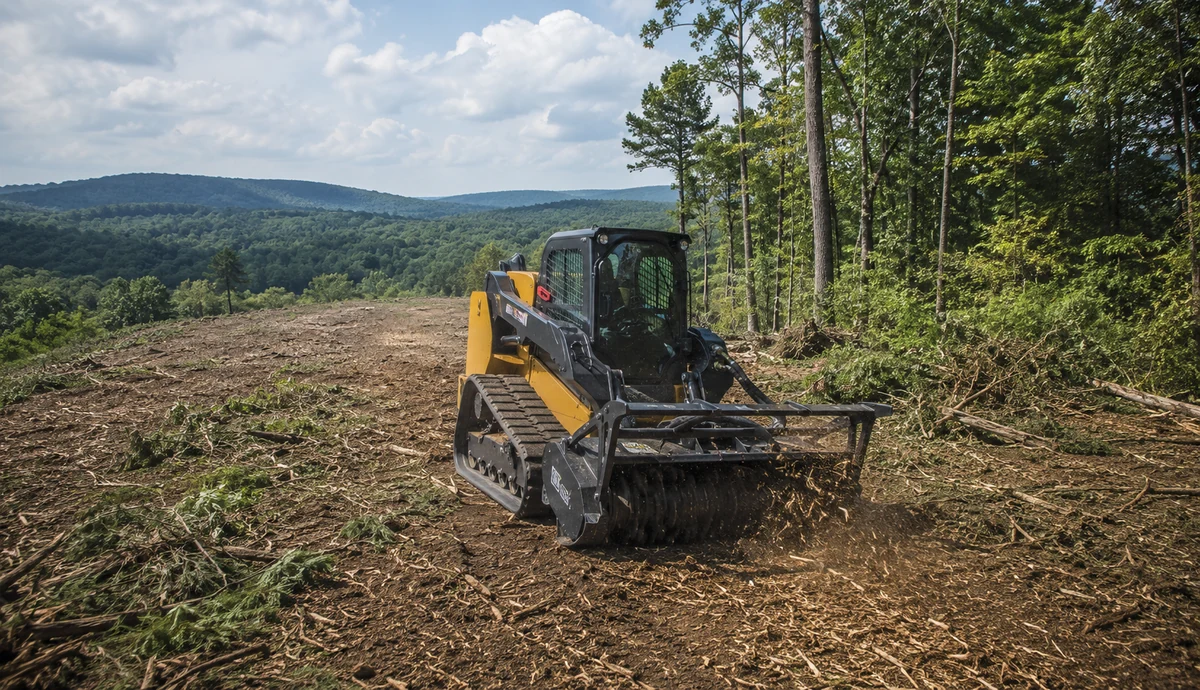 Tracked land-clearing machine opening a wooded rural property